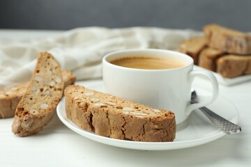 Traditional Italian almond biscuits (Cantucci) and coffee on white table, closeup
