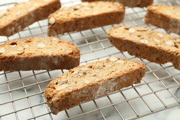 Traditional Italian almond biscuits (Cantucci) on white marble table, closeup