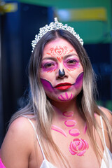 Adult Hispanic woman in Catrina makeup celebrating Mexican tradition.