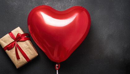 Fototapeta premium Red heart shaped balloon with craft paper wrapped gift box on a dark textured background. Valentines day concept. Copy space