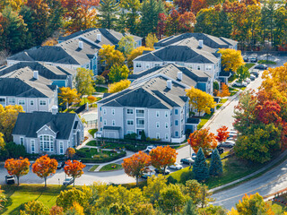 aerial view of community with solar panel installed on apartment building roof 