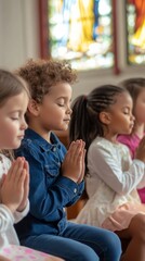 Fototapeta premium Children in Prayer at a Church with Stained Glass Windows