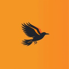 Obraz premium A black bird with orange accents flies against a bright orange background, creating a striking visual.