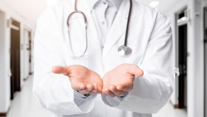 Closeup of unrecognizable doctor holding invisible object on his open palms, standing over white...