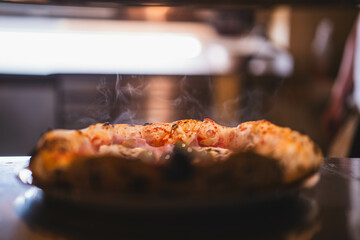 A hot pizza straight from the oven, with steam rising off its surface. This image is great for advertisements or social media posts focused on hot, fresh meals.