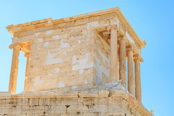 A building with white pillars and a white roof, the Acropolis of Athens