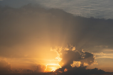 Red sunset with clouds on the sky background. Sky with clouds and sun. Beautiful dramatic sky with clouds at sunset or sunrise. Sun rays. Skyscape nature composition. Natural sky background.