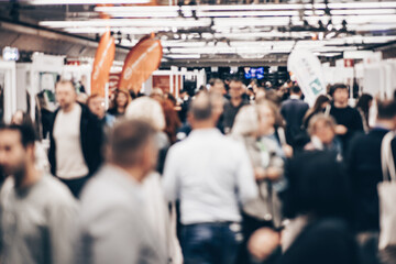 Fototapeta premium Abstract blurred people at exhibition hall of expo event trade show. Business convention show or job fair. Business concept background