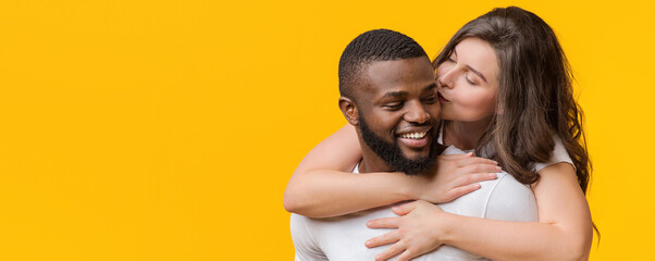 Romantic Moments. Loving Woman Kissing And Hugging Her Afro Boyfriend From Behind