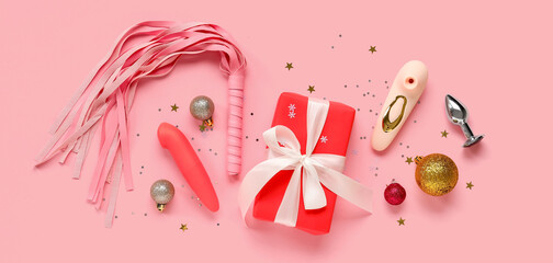 Composition with Christmas gift, sex toys and decorations on pink background