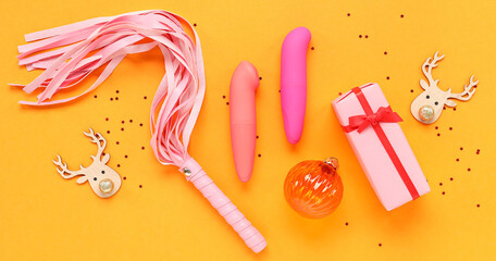 Composition with sex toys, Christmas gift and decorations on color background