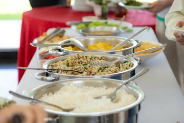 Traditional Brazilian system of serving food in a self-service buffet. Feijão tropeiro, cassava, barbecue, feijoada