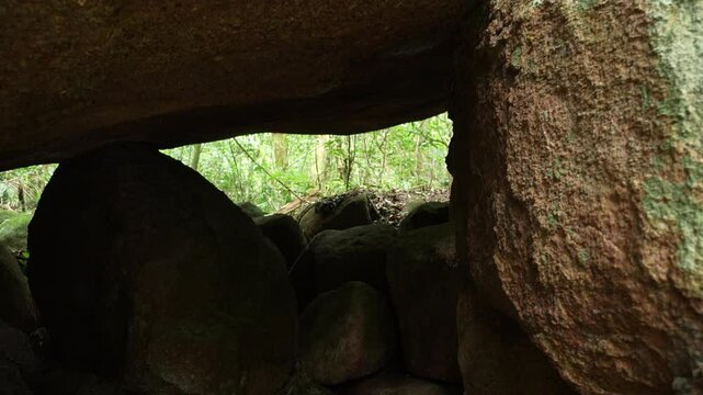 Little cave inside an bigf rock stream water