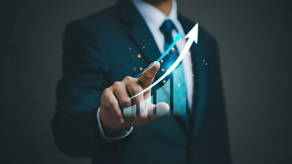 Businessperson touching futuristic graph interface, indicating growth.