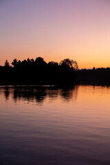 Golden sunset on lake with reflection