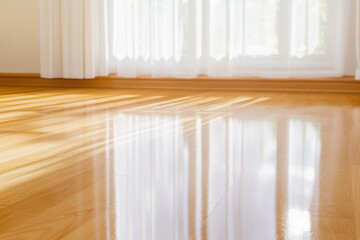 Sunlit Hardwood Floor with Bright Window Shadows in a Modern Interior