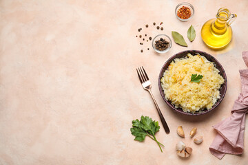 Bowl with delicious sauerkraut and different spices on pink background