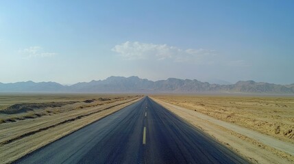 Endless Road Through Arid Landscape with Mountains