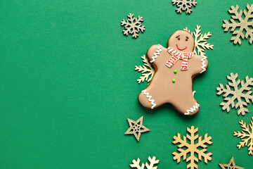 Christmas sweet gingerbread cookie with snowflakes and stars on green background
