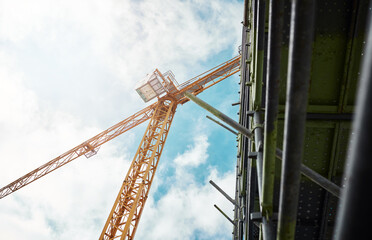 Machine, development and equipment in construction site with crane, building or structure of metal....