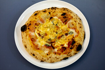 Traditional rustic pizza made with four cheeses, garlic and oil and pear with gorgonzola