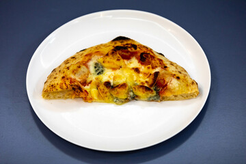 Traditional rustic pizza made with four cheeses, garlic and oil and pear with gorgonzola
