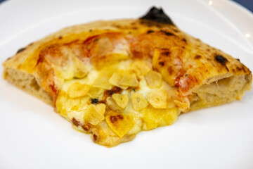 Traditional rustic pizza made with four cheeses, garlic and oil and pear with gorgonzola