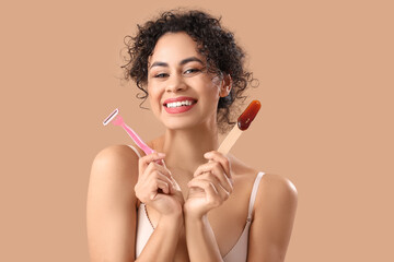 Beautiful African-American woman with razor and sugaring paste on beige background. Hair removal...