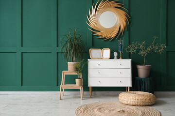 Interior of living room with golden mirror and commode