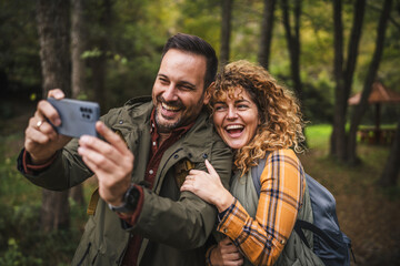 husband and wife hiker take a self portrait or video call on hiking