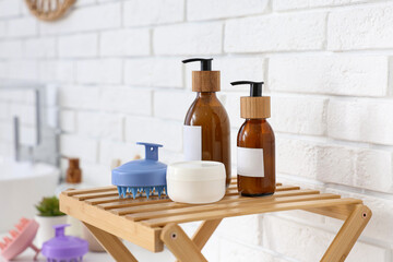 Hair scalp massager and cosmetic products on shelving unit in bathroom