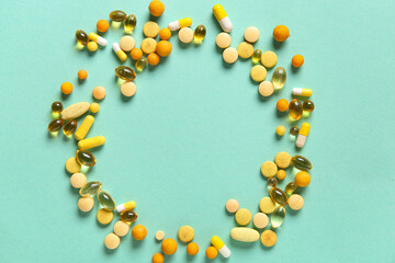 Frame made of different pills on turquoise background, closeup