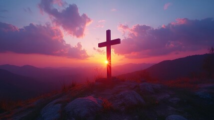 Cross on a mountain during sunset with vibrant sky, spiritual and peaceful concept