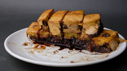 close up of sweet martabak or pancakes with peanuts and melted chocolate inside