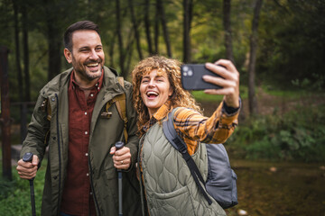 husband and wife hiker take a self portrait or video call on hiking