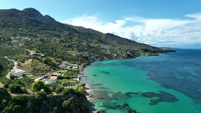 Flying over the beautiful blue waters of a beach on the island of Zakynthos. Mavic 3