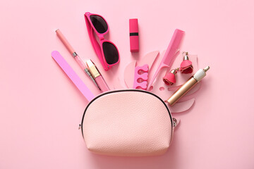 Composition with bag, cosmetics and accessories on pink background