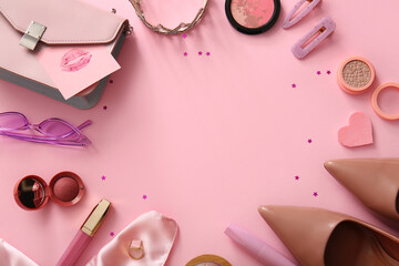Frame made of stylish female accessories, shoes and cosmetics on pink background