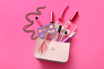 Composition with stylish female handbag, decorative cosmetics and accessories on pink background