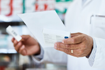 Person, hands and pharmacist with prescription for medication, checklist or diagnosis at pharmacy. Closeup, healthcare or employee with pharmaceuticals for side effects or symptoms at dispensary