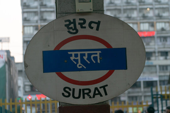 Surat, India - 25 April 2024, Platform board, sign name plate at Surat railway station(western railway) written in Hindi, Gujarati and English. Local, traffic, rains, accident, mega block, bullet