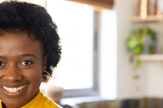 Smiling african american woman enjoying thanksgiving celebration at home, copy space