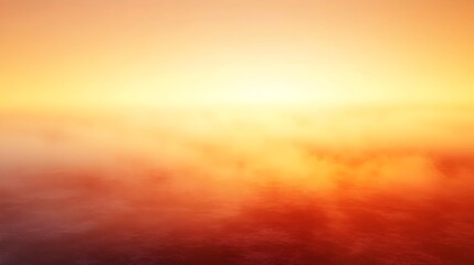 Obraz premium A serene landscape featuring a vibrant sunset over a calm body of water, casting warm orange and yellow hues across the sky and reflecting softly on the water's surface.