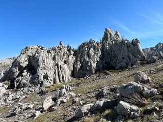 Rocky ridge of Tulove grede or karst mountain peak of Tulovice - Velebit Nature Park, Croatia (Stjenoviti greben Tulove grede ili krški planinski vrh Tulovice - Park prirode Velebit, Hrvatska)