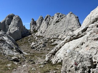 Rocky ridge of Tulove grede or karst mountain peak of Tulovice - Velebit Nature Park, Croatia (Stjenoviti greben Tulove grede ili krški planinski vrh Tulovice - Park prirode Velebit, Hrvatska)