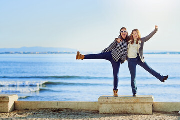 Friends, women and outdoor hug by ocean, bonding and travel to Berlin on weekend trip. People, happy together and peace on vacation to beach water, embrace and united in sisterhood or relationship