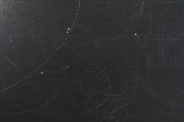 Texture of scratched black surface as background, closeup