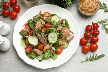 Delicious fresh tuna salad on grey table, flat lay
