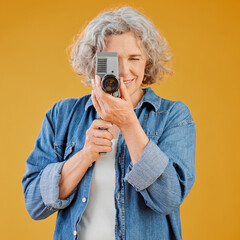 Senior woman, vintage and camera for film, recording video or shooting movie for filmmaking....