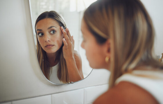 Woman, bathroom and checking face in mirror for acne breakout, pimple inspection or beauty routine. Skincare, person and reflection for cosmetics facial results, analysis or hyperpigmentation in home
